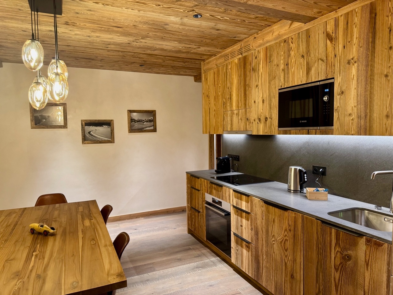 Appartement 3 – cuisine et salle à manger en bois avec suspensions